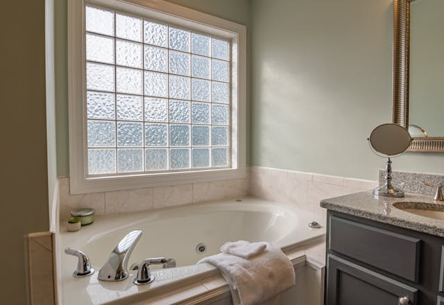 A bathroom with a big, mate window